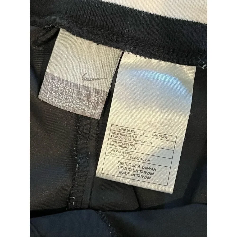 Nike black track pants with white side stripes and ankle zippers - L